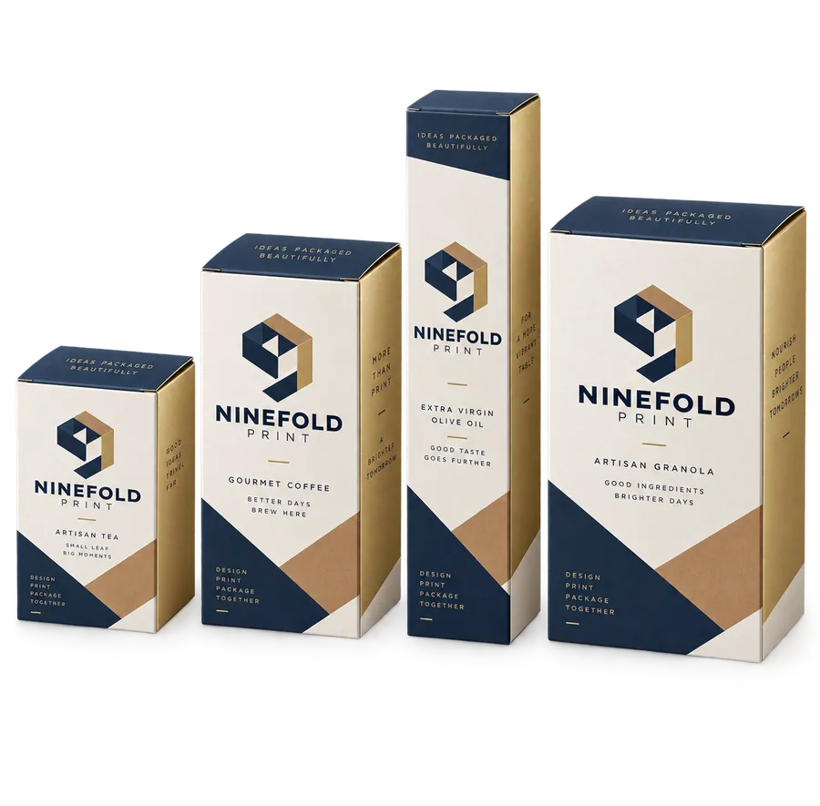 Four folding cartons in ascending sizes with navy, kraft and gold panels
